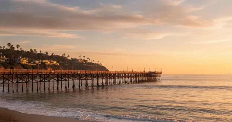 Photorealistic image of the San Clemente pier at golden hour, with calm ocean waves, no people visible, warm coastal Californ